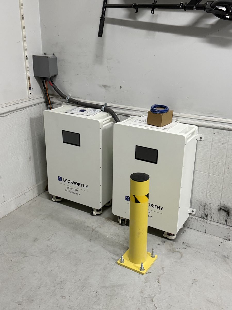 Battery storage cabinets with a protective bollard in a garage